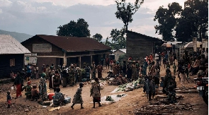 War-displaced women gather at a small roadside market in the Kalinga IDP camp