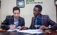 , D. A Okraku looks on during signing session with MD of Ezzy Paints Moussa Ezzedenne