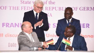 President Frank Steinmeier looks on as Prof. Mehler shakes Prof. Dodoo after the signing