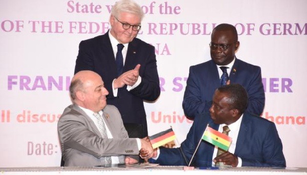 President Frank Steinmeier looks on as Prof. Mehler shakes Prof. Dodoo after the signing