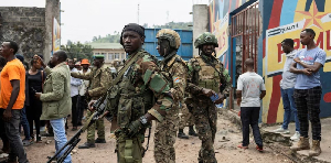 M23 rebels stand guard during a meeting organised by the M23 at the Stade de l'Unite