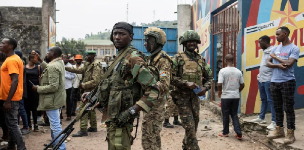 M23 rebels stand guard during a meeting organised by the M23 at the Stade de l'Unite