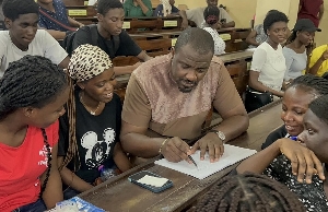 John Dumelo with some students
