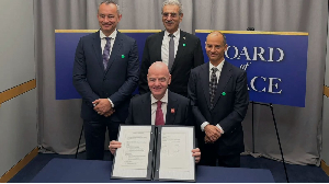FIFA President Gianni Infantino holding the signed documents on peace promotion