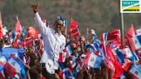 Rwandan president Paul Kagame waves to party supporters during a campaign