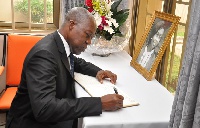 Amissah-Arthur signing the Book of Condolence