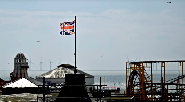 A Union Jack flag flies from a pole above Clacton Pier, eastern England, on June  4, 2024