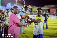 Dr Fred Kyei Asamoah presenting the trophy to the winning team