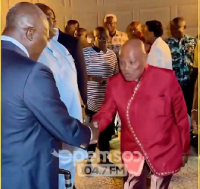 The Asantehene captured in a handshake with some members of the Ghanaian community and officials