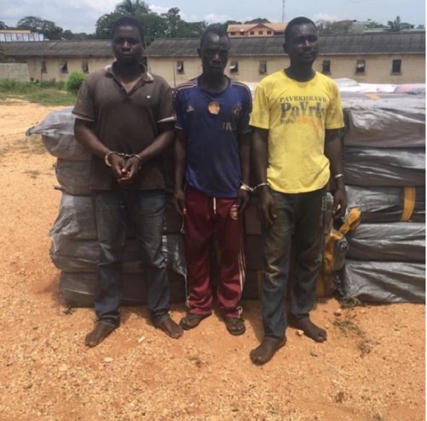 The three arrested suspects behind the bales of wee