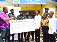 Edward Abakah-Hanson, Southern Zonal Manager at StarLife Assurance (1st left), presenting the cheque