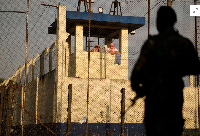 Inmates gather at a security tower at the Renovacion 1 prison