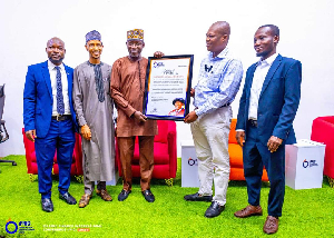 Prof Gatsi ( second from right ) receiving his award from representatives of IFRIG