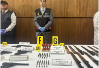 1 of 4 An agent from the Central Bureau for Judicial Investigations (BCIJ) stands behind items