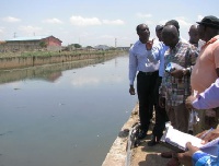 Samuel Atta Akyea (2nd right) inspecting dredging works in some drains in Accra