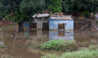 A house stands partially submerged in floodwater after weeks of heavy rainfall in Maputo, Mozambique