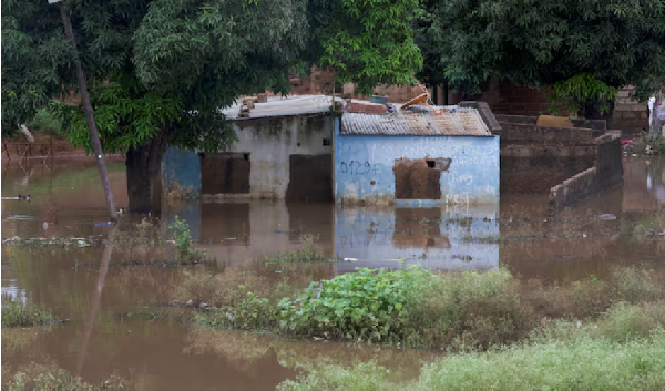 A house stands partially submerged in floodwater after weeks of heavy rainfall in Maputo, Mozambique