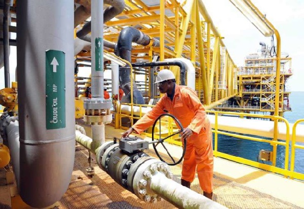 A Ghana Gas operations officer examining a pipeline