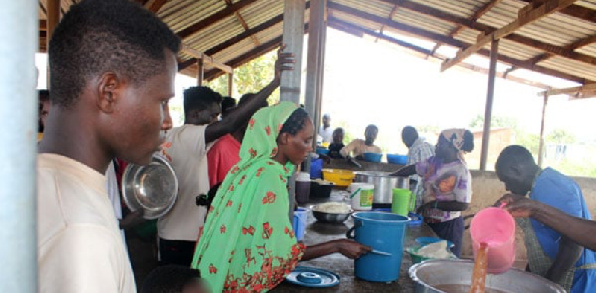 Some of the refugees who fled from Khartoum in Sudan following continued fighting, receive food
