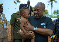 President Mahama carries child and reassures him as a proud African, not a slave