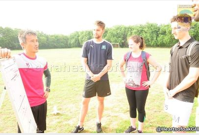 Hearts coach Kenichi Yatsuhashi having a chat with the three physiotherapists.