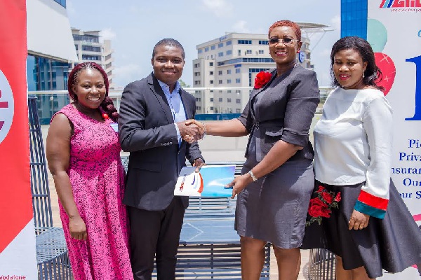 Officials from Glico and Vodafone at the signing