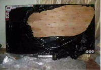 The wood was wrapped with black polythene with stickers looking like a brand new TV