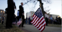 A flag is seen during a candlelight vigil