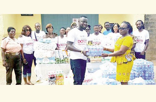 Nkosuohene presenting the items to an official from the Nsawam Female Prisons