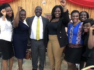 Ralph Ayitey flanked by some staff of Groupe Nduom