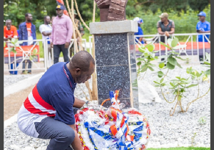 Napo Laying A Wreath On Busia's Grave.png