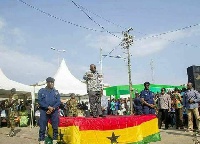 President Akufo-Addo delivering a speech from the mounted stage decorated with the Ghana Flag