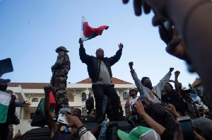 Protesters have gathered on a military vehicle in Antananarivo, over power and water shortage