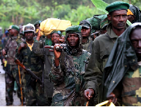 File photo of M23 rebel fighters walk as they withdraw near the town of Sake