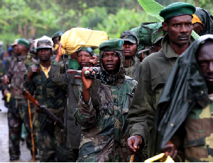File photo of M23 rebel fighters walk as they withdraw near the town of Sake