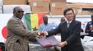 Mr Mark Woyongo receiving relief items from Japanese Ambassador, H.E. Kaoru Yoshimura