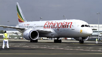 A member of the ground crew directs an Ethiopian Airlines Boeing 787-8 Dreamliner plane