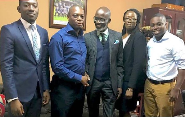 Dr. Kingsley Nyarko in a handshake with Gabby Asare Otchere-Darko (middle)