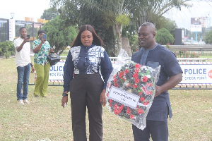 GIHOC CEO Johnes Borteye Applerh lays flowers in honour of the eight victims of the helicopter crash