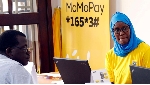 MTN customer care staff attend to a client during an expo in Kampala, Uganda