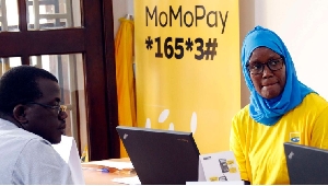 MTN customer care staff attend to a client during an expo in Kampala, Uganda