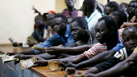 People jostle to exchange their currencies in a local bank in Juba, South Sudan