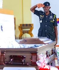 Dr George Akuffo Dampare saluting the mortal remains of General Lance Corporal Callistus Amoah
