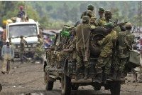 Congolese army personnel is seen at the back of truck