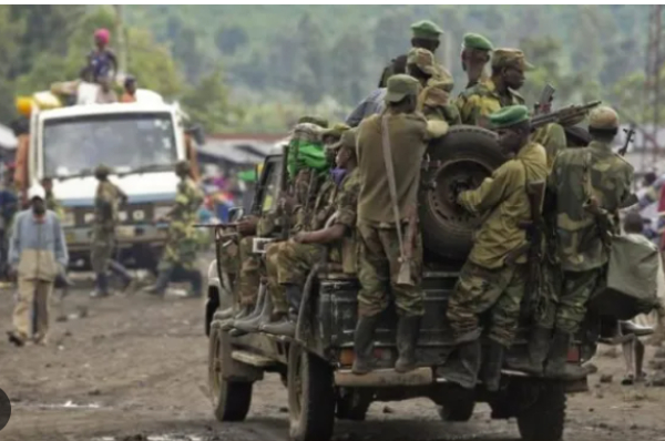 Congolese army personnel is seen at the back of truck