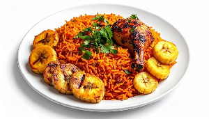 A plate of Ghanaian jollof rice served with fried plantain and chicken