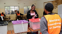 A woman casts a vote at a polling station in Lusaka, Zambia