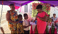 Rachel Appoh presenting gifts to some of the children