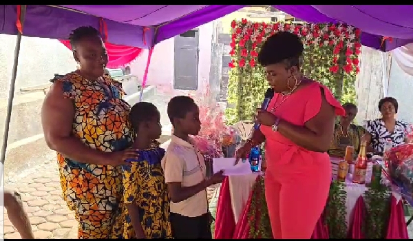 Rachel Appoh presenting gifts to some of the children