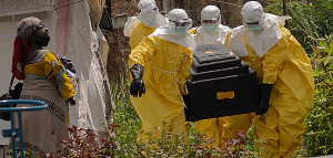 A woman cries as Red Cross workers carry the coffin of a person who died of Ebola